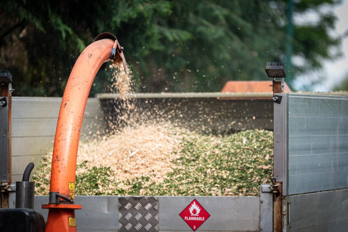 Wood chipper blowing chippings into a trailer